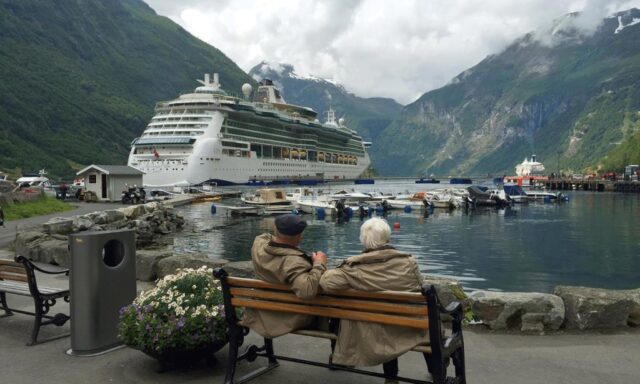 Creating-Flexible-Income-in-Retirement_Roth-Conversions_Two-Older-Gentlemen-looking-at-a-Cruise-ship-in-a-nordic-location